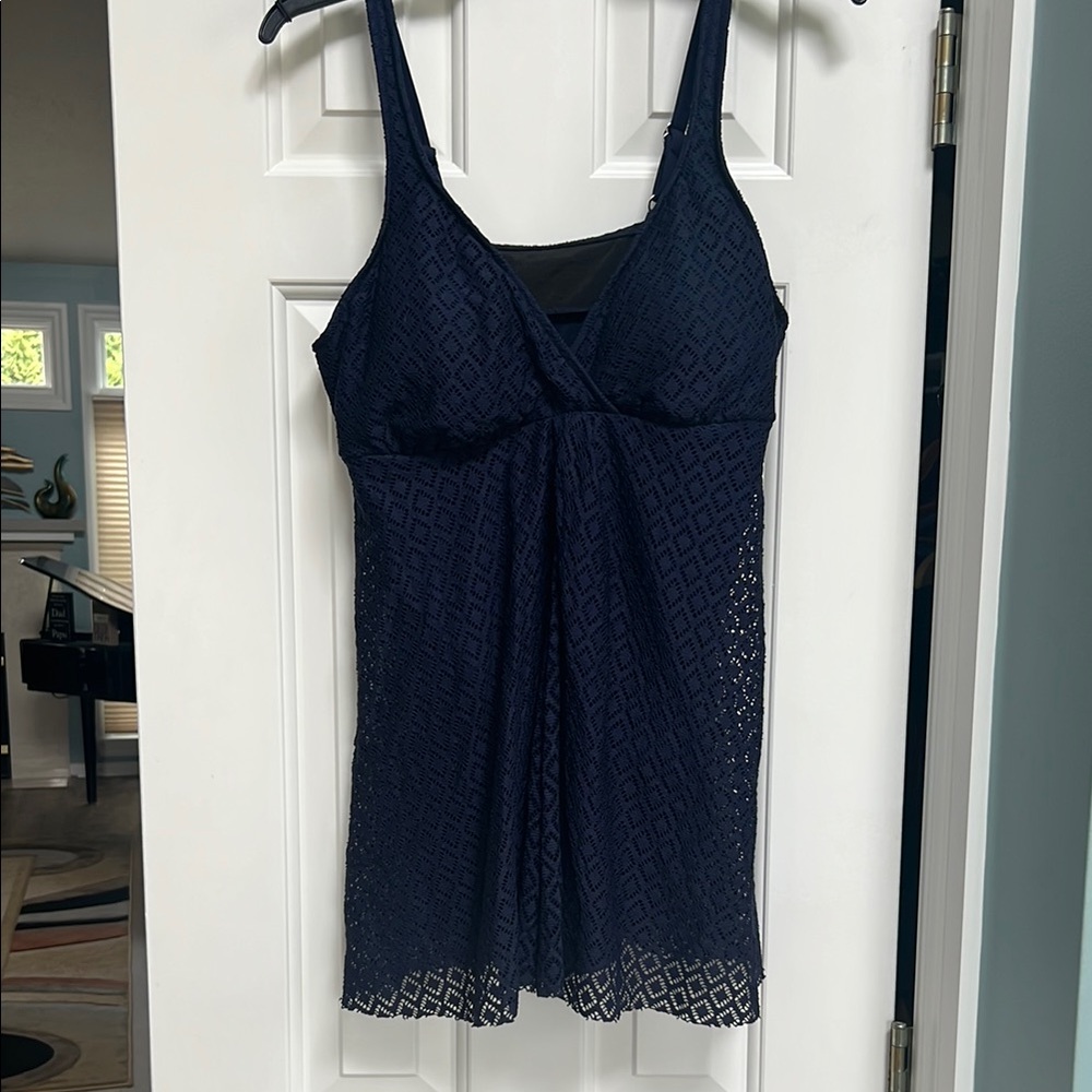 Navy one piece bathing suit with flyaway mesh overlay.
